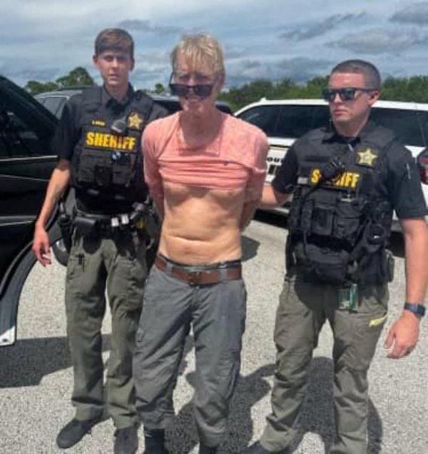Routh appears to be smiling after being arrested on Sunday.
